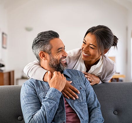 laughing couple on couch